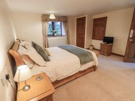 A bedroom with bed and television at Christine's Stable in Shap near Maulds Meaburn