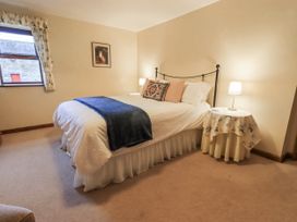 A bedroom with a bed and bedside tables at Christine's Stable in Shap near Maulds Meaburn