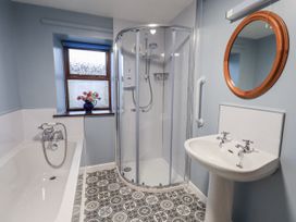 A bathroom with a shower, bathtub, and sink at Christine's Stable in Shap near Maulds Meaburn