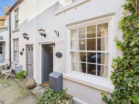 An outdoor area with a door and window at Delft Cottage in Robin Hood's Bay