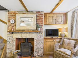 A living room with a fireplace and television at Delft Cottage Robin Hood's Bay