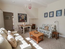 A living room with sofa and dining table at Riverside Cottage Llanwrthwl near Rhayader