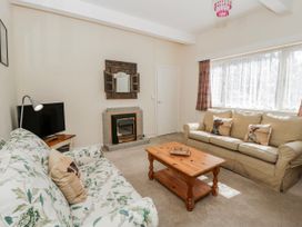 A living room with a sofa and television at Riverside Cottage Llanwrthwl near Rhayader
