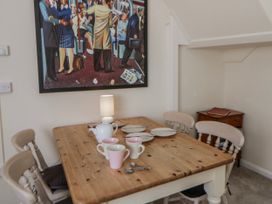 A dining room with a wooden table and chairs at Riverside Cottage Llanwrthwl near Rhayader