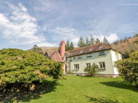 A house with bushes in front at Riverside Cottage Llanwrthwl near Rhayader