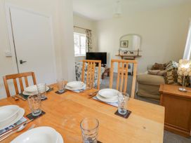 A dining room with a table set for dinner at Gardener's Cottage in Llanwrthwl near Rhayader