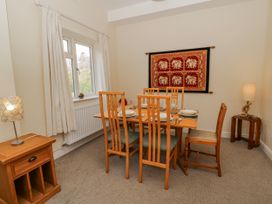 A dining room with a table set for dinner at Gardener's Cottage in Llanwrthwl near Rhayader