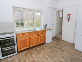 A kitchen with countertops and appliances at Gardener's Cottage Llanwrthwl near Rhayader