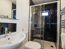 A bathroom with a sink, toilet, and shower at Jenny Wren in Tywardreath near Fowey
