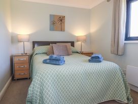 A bedroom with a bed and bedside tables at The Station Flat St Newlyn East near Newquay