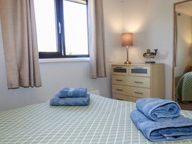A bedroom with bed and towels at The Station Flat St Newlyn East near Newquay
