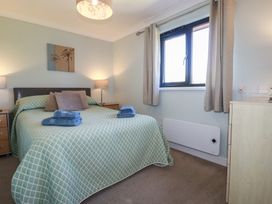 A bedroom with a bed and window at The Station Flat St Newlyn East near Newquay