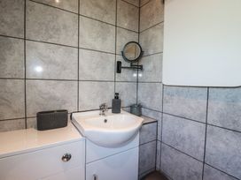 A bathroom with a sink and mirror at The Station Flat in St Newlyn East near Newquay