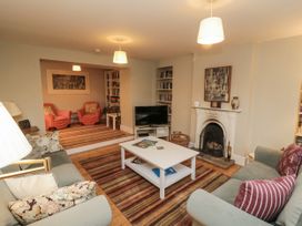 A living room with a coffee table and bookshelf at Brookleigh in Hutton-le-Hole