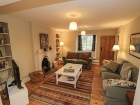 A living room with sofa and bookshelf at Brookleigh in Hutton-le-Hole