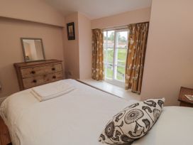 A bedroom with a bed and wooden dresser at Brookleigh in Hutton-le-Hole