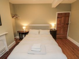 A bedroom with a bed and a lamp at Brookleigh in Hutton-le-Hole
