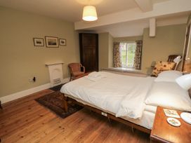 A bedroom with a bed and chair at Brookleigh in Hutton-le-Hole