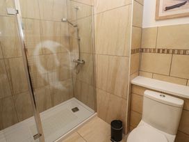 A shower and toilet in a bathroom at Apartment 1 Llewellan in St Ives