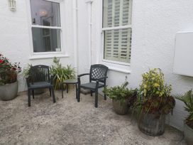 A outdoor area with chairs and planters at Apartment 1 Llewellan in St Ives