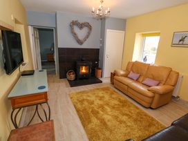 A living room with a sofa and fireplace at Ballaghboy Cottage in Boyle, County Sligo
