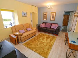 A living room with sofas and a rug at Ballaghboy Cottage Boyle, County Sligo