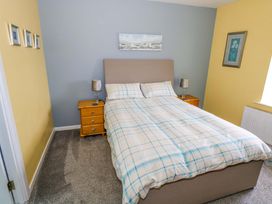 A bedroom with a bed and bedside tables at Ballaghboy Cottage in Boyle, County Sligo