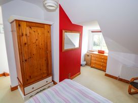 A bedroom with a wardrobe and dresser at Ballaghboy Cottage in Boyle, County Sligo