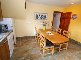 A kitchen with a dining table and chairs at Ballaghboy Cottage in Boyle, County Sligo