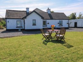 A house with a table and chairs in front at Ballaghboy Cottage, Boyle, County Sligo