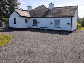 A house with windows and a bench in the outdoor area at Ballaghboy Cottage Boyle, County Sligo