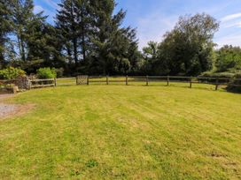 A garden with grass and a fence at Ballaghboy Cottage in Boyle, County Sligo