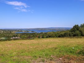 A view of a lake surrounded by trees and hills at Ballaghboy Cottage in Boyle, County Sligo