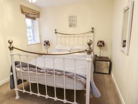 A bedroom with a bed and nightstand at Beach View in Benllech near Red Wharf Bay