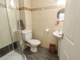A bathroom with a shower, toilet, and sink at Beach View in Benllech near Red Wharf Bay