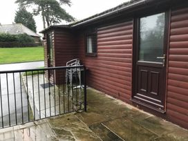 An outdoor area with a door and chairs at Bluebell Lodge in Saltburn-by-the-Sea