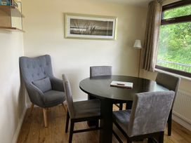 A dining room with a round table and chairs at Bluebell Lodge Saltburn-by-the-Sea