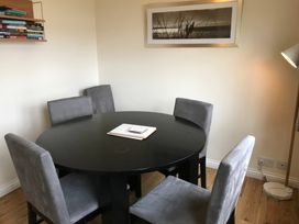 A dining room with a round table and four chairs at Bluebell Lodge in Saltburn-by-the-Sea