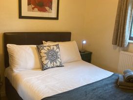 A bedroom with a bed and bedside table at Bluebell Lodge Saltburn-by-the-Sea
