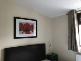 A bedroom with framed artwork and a bed at Bluebell Lodge Saltburn-by-the-Sea