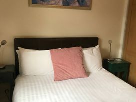 A bedroom with a bed and nightstand at Bluebell Lodge in Saltburn-by-the-Sea