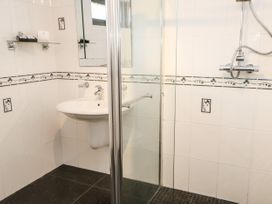 A bathroom with a sink and glass shower enclosure at Violet Lodge in Saltburn-by-the-Sea