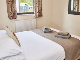 A bedroom with a bed and towels at Violet Lodge Saltburn-by-the-Sea