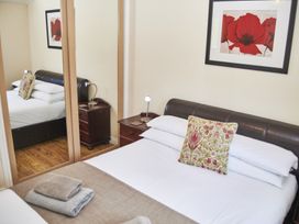 A bedroom with a bed and side table at Violet Lodge in Saltburn-by-the-Sea