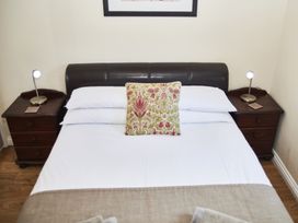 A bedroom with a bed and bedside tables at Violet Lodge in Saltburn-by-the-Sea