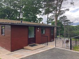 A cabin with decking and chairs at Violet Lodge in Saltburn-by-the-Sea