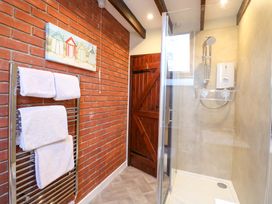 A bathroom with a shower and towel radiator at Sweet Briar Barn, Coltishall, Norfolk Broads