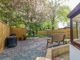 A garden with a tree and gravel area at Ty Taid in Llanddaniel Fab near Beaumaris