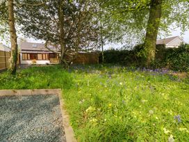 A garden with flowers and a house at Ty Taid in Llanddaniel Fab near Beaumaris