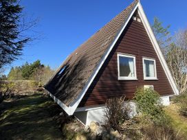 A house with a sloped roof and windows at Suil Na Mara Aultbea